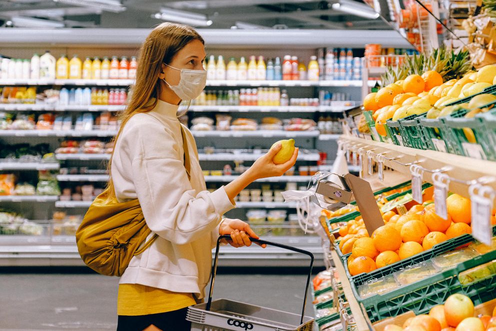 A woman choosing nutrient-dense foods to support focus and manage ADHD symptoms naturally.