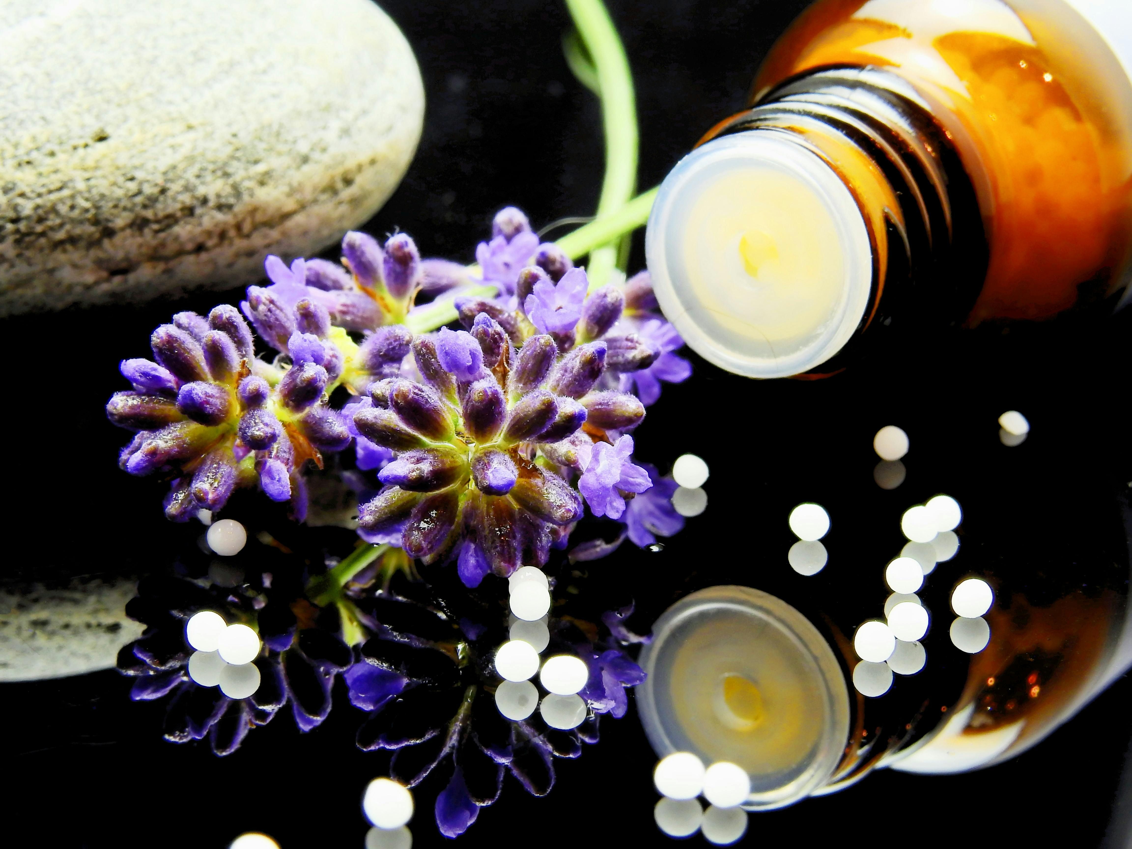 A bottle of lavender essential oil with fresh lavender flowers, used for relaxation and weight loss support.