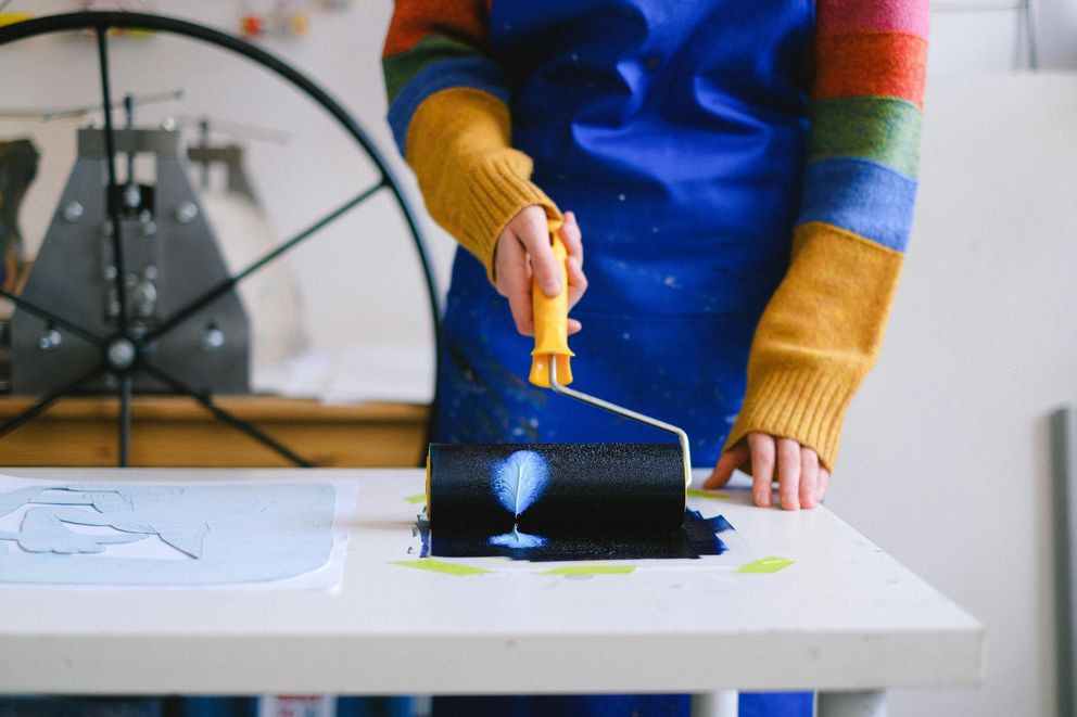 A woman painting as a creative outlet to promote mental health, resilience, and longevity.