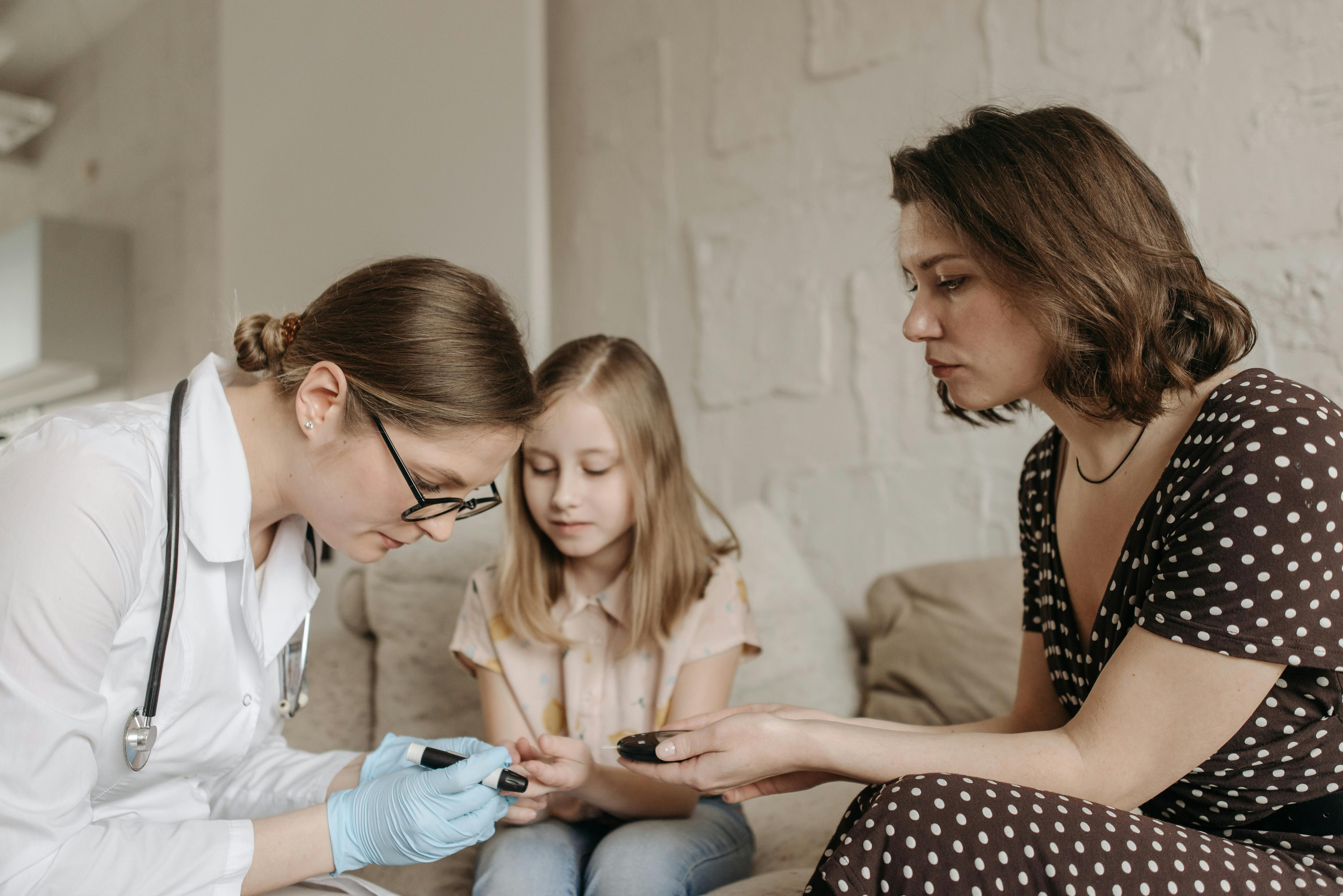 A female doctor assisting a woman in measuring her glucose level, emphasizing the importance of proper diabetes management.