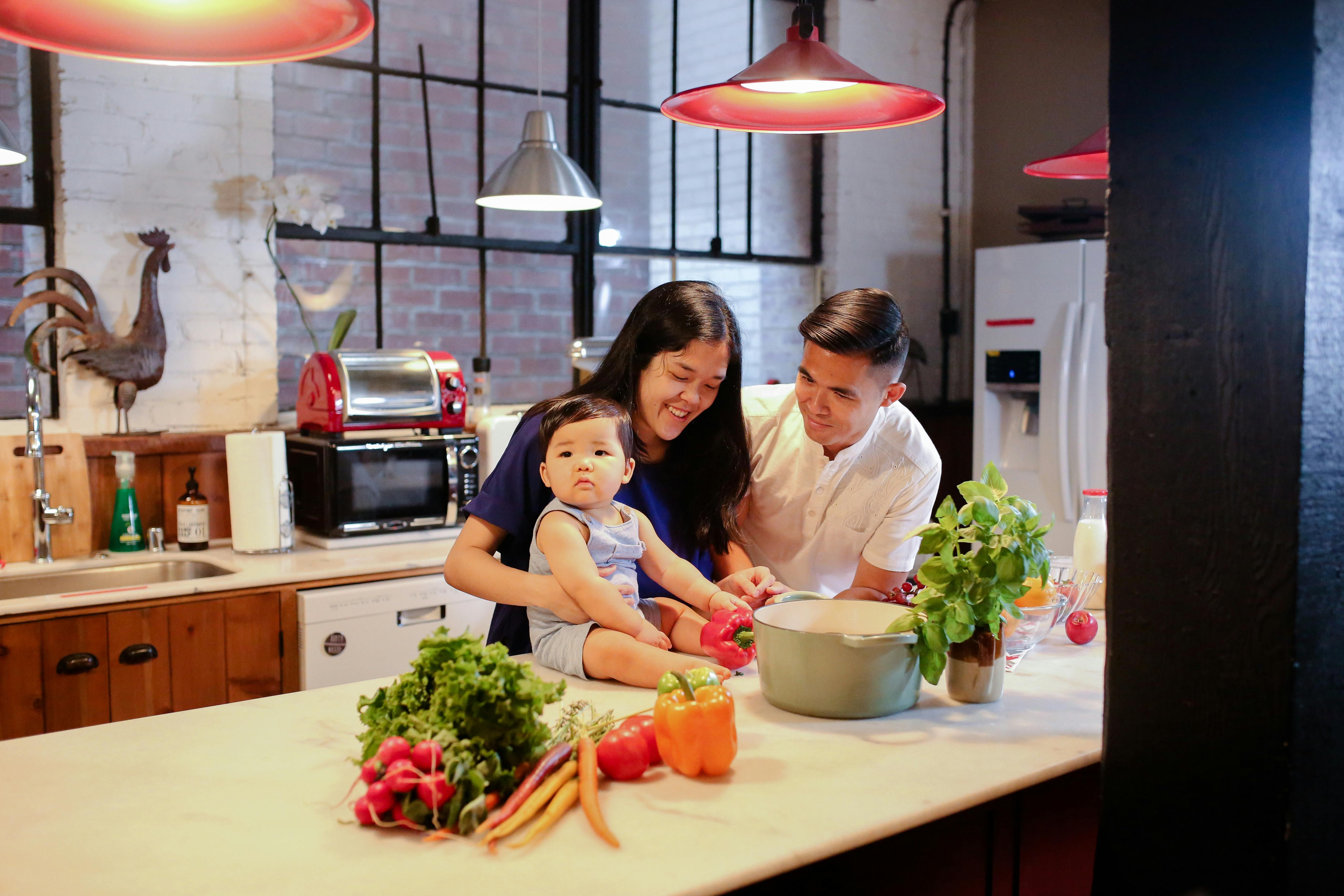 A family cooking together in the kitchen, showcasing the importance of preparing healthy meals as part of a circadian fasting routine.