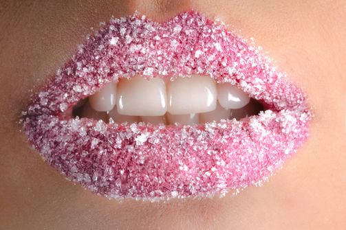 Close-up of a woman's lips dusted with sugar, symbolizing cravings during intermittent fasting.