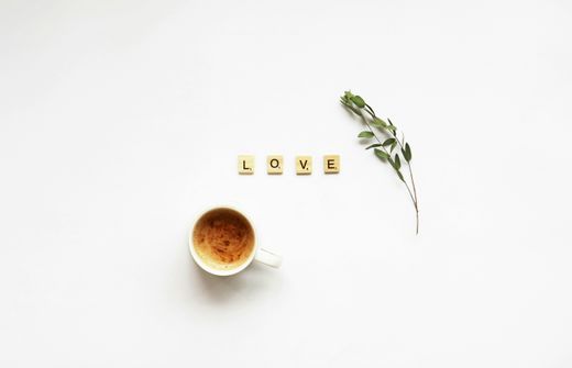 A bottle of MCT oil next to a cup of bulletproof coffee with the word LOVE