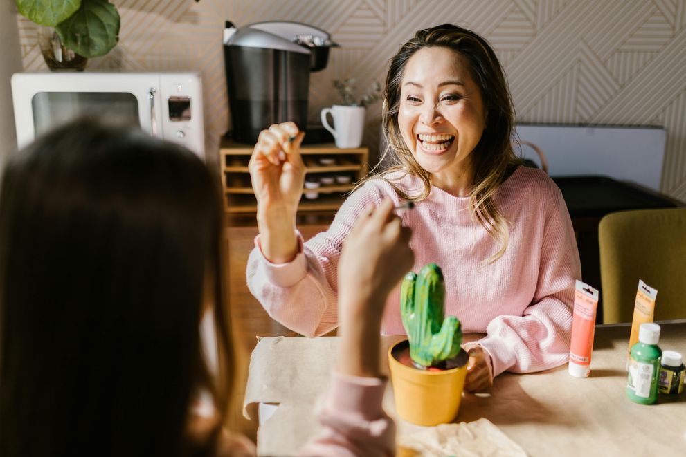 A group of women sharing a moment of joy and connection, supporting each other for better emotional and physical health.