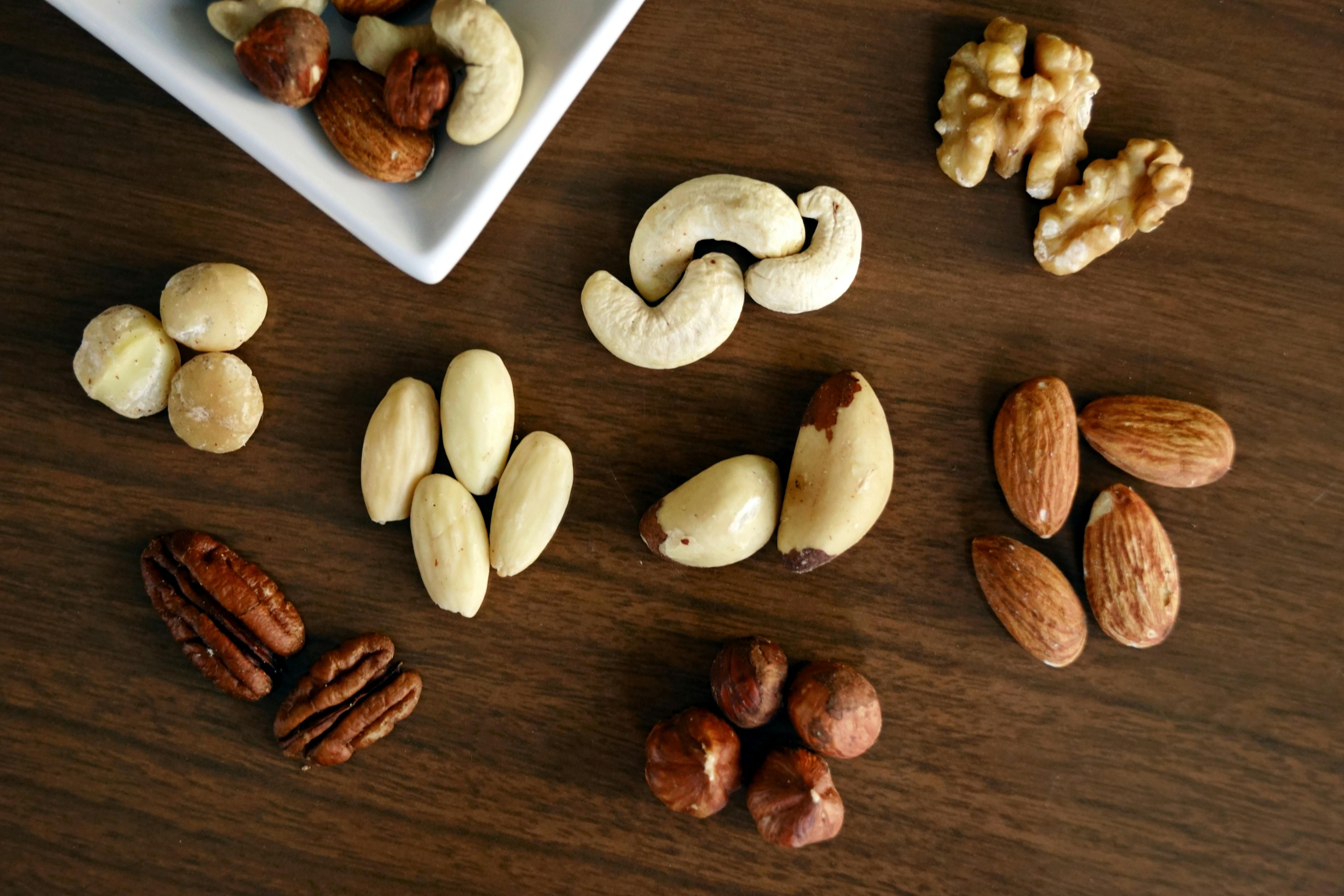 A variety of healthy nuts, including almonds and walnuts, ideal as snacks for maintaining weight loss while traveling.