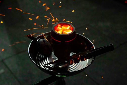 A woman experiencing the harmful effects of using hookahs, highlighting risks like respiratory issues, cancer, and infectious diseases.