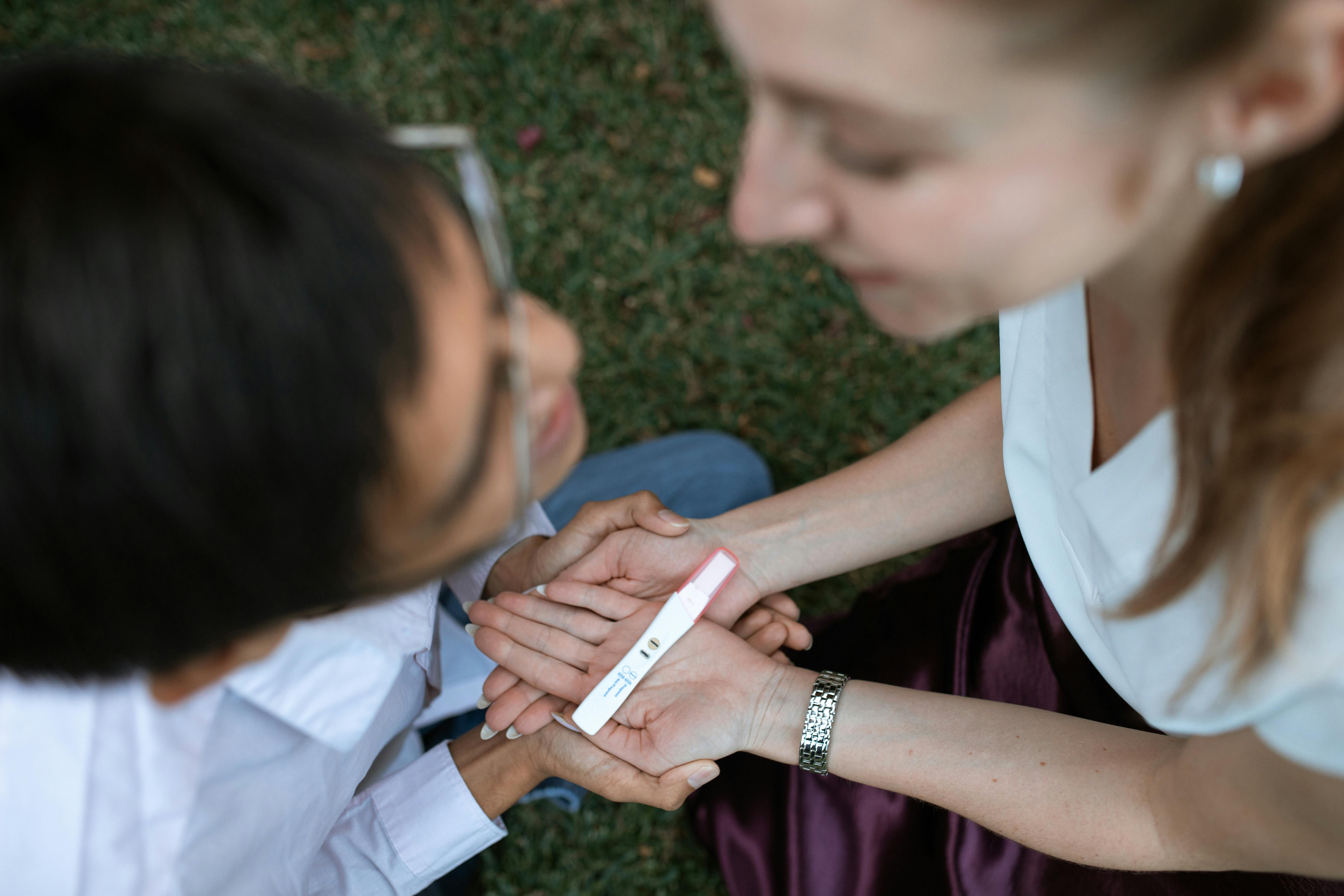 Joyful couple embracing as they discover positive pregnancy test, embodying hope and happiness