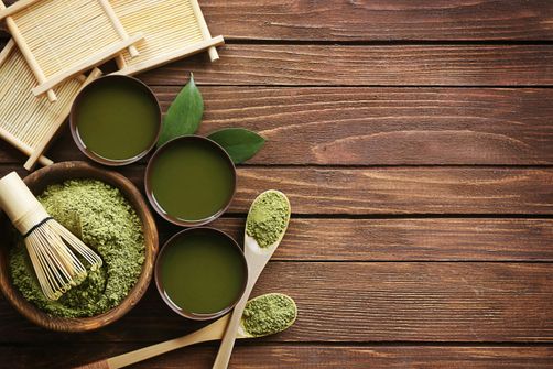 A woman enjoying a cup of matcha tea, highlighting the benefits of matcha for weight loss, metabolism boosting, and reducing cravings.