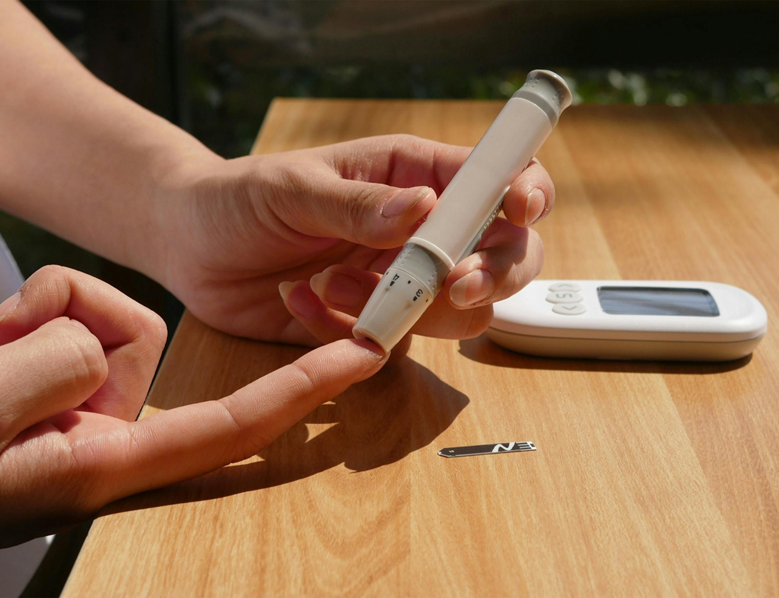 Woman checking blood sugar levels with glucometer during intermittent fasting