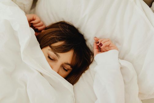 Woman enhancing sleep quality with melatonin supplementation