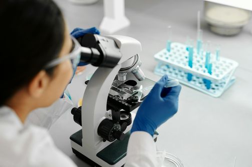 A woman preparing a balanced meal tailored to her genetic profile to promote health and longevity.