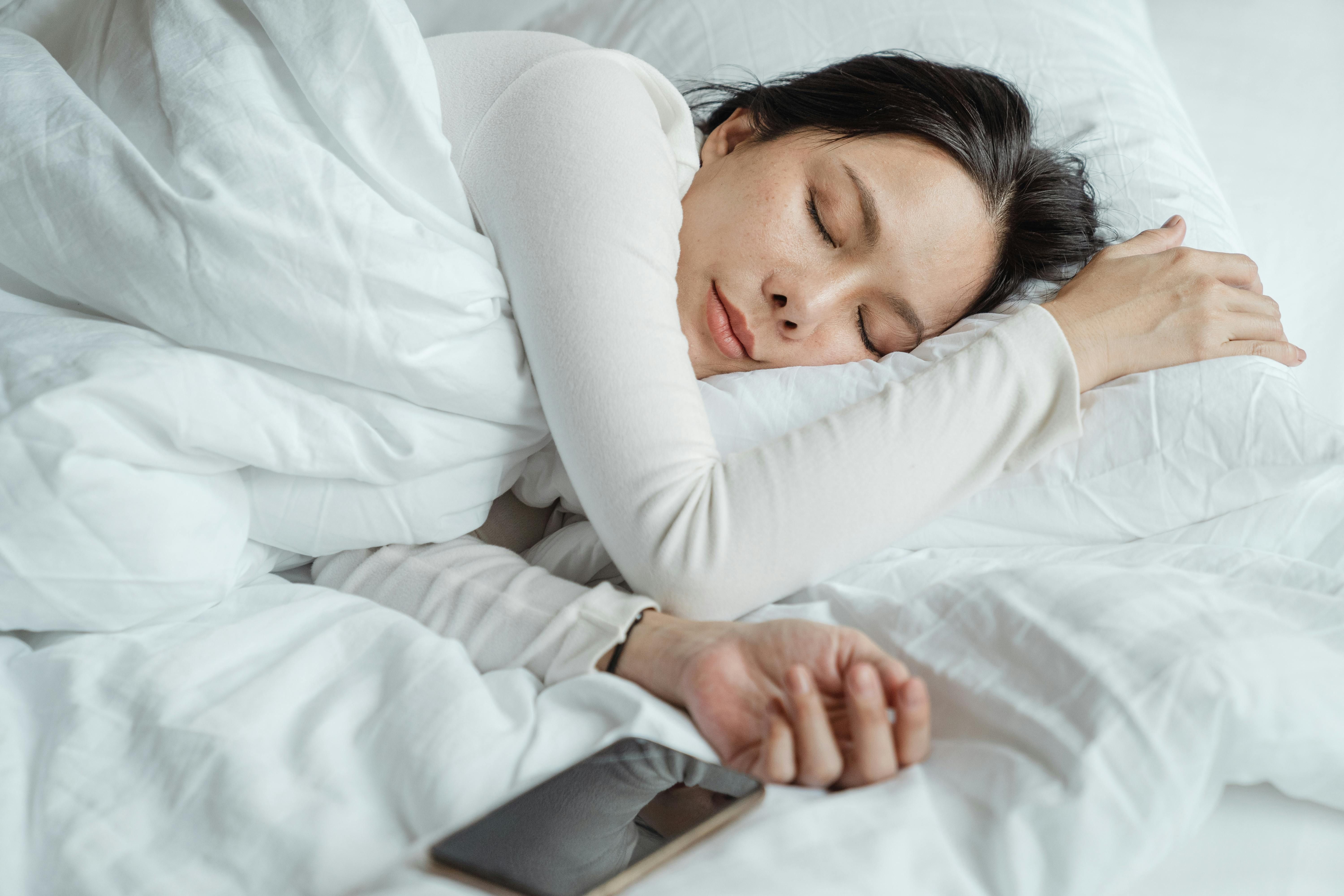 Peaceful woman sleeping, illustrating the importance of sleep during fasting periods