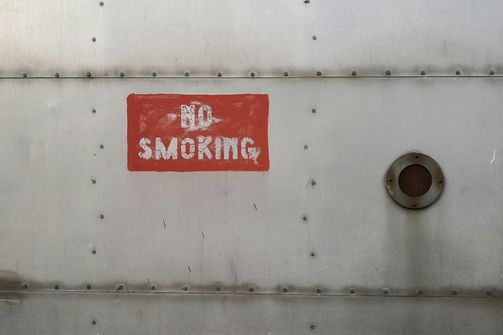 A woman experiencing the harmful effects of smoking, highlighting risks like heart disease, lung cancer, and reproductive health issues.