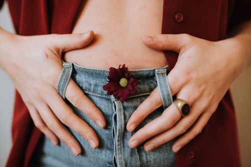 The woman holds her belly after taking supplements