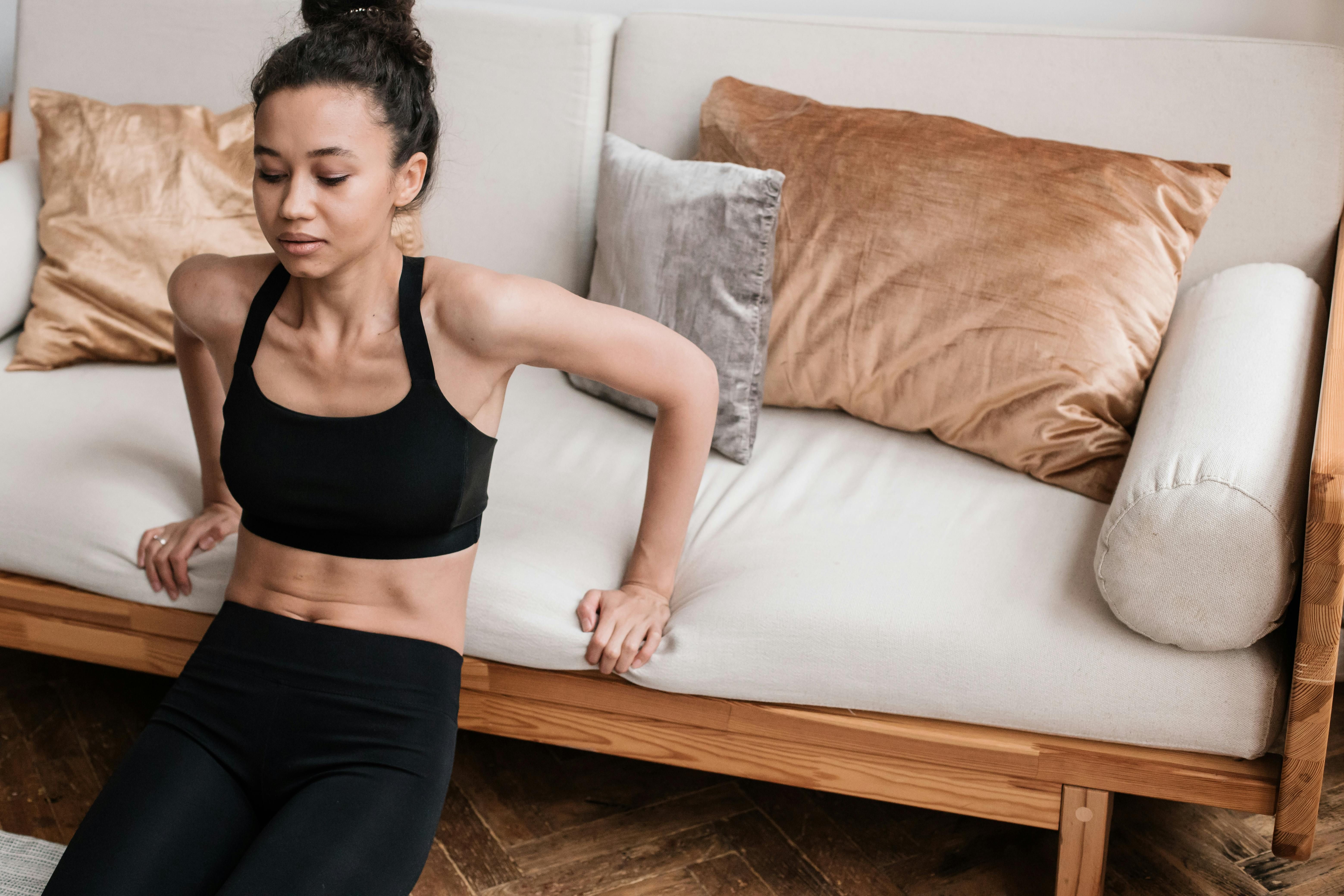 Woman intensely focused on her body, reflecting dedication to fitness and self-improvement