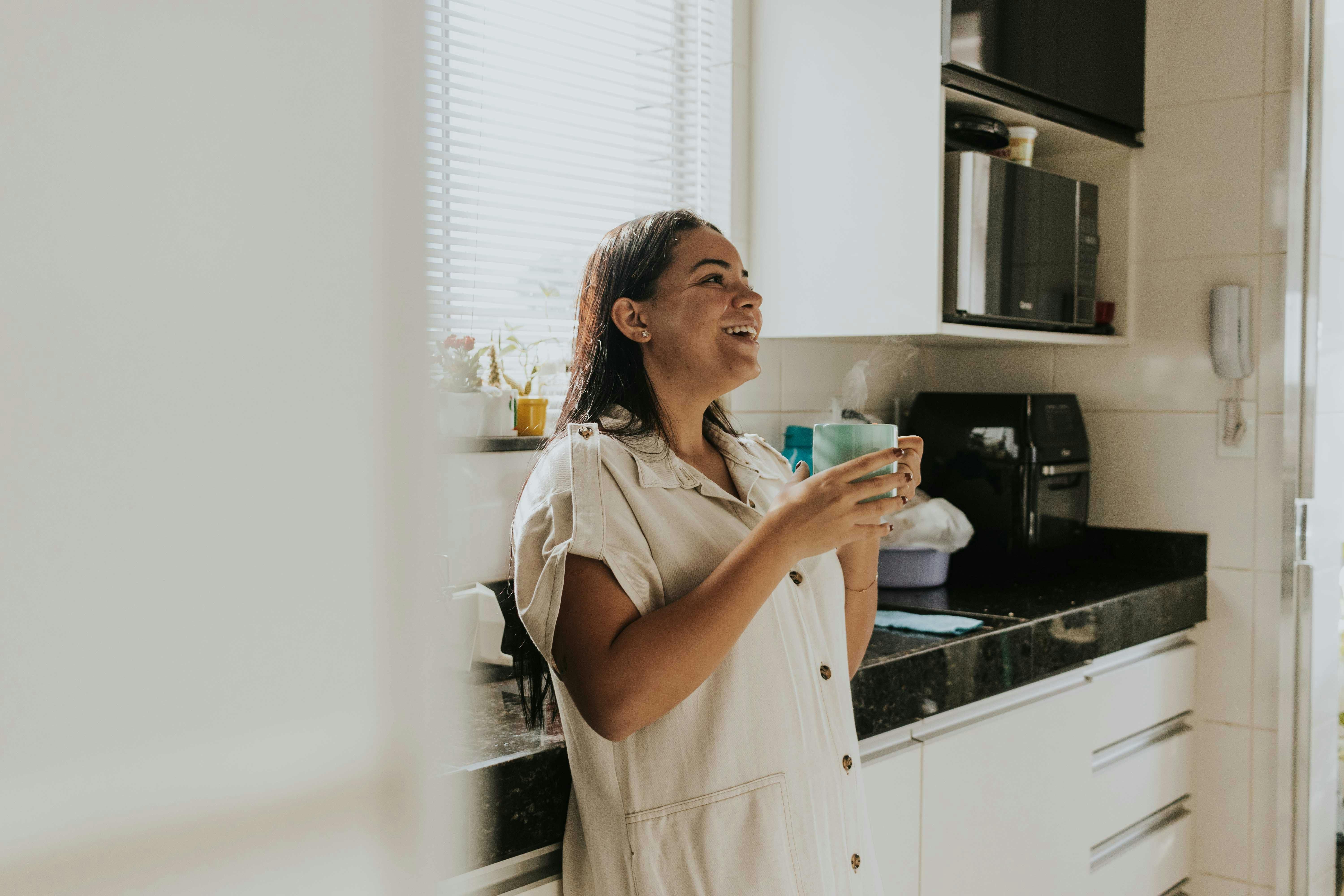 A woman enjoying a cup of coffee while staying mindful of hydration, balancing caffeine intake for better health.