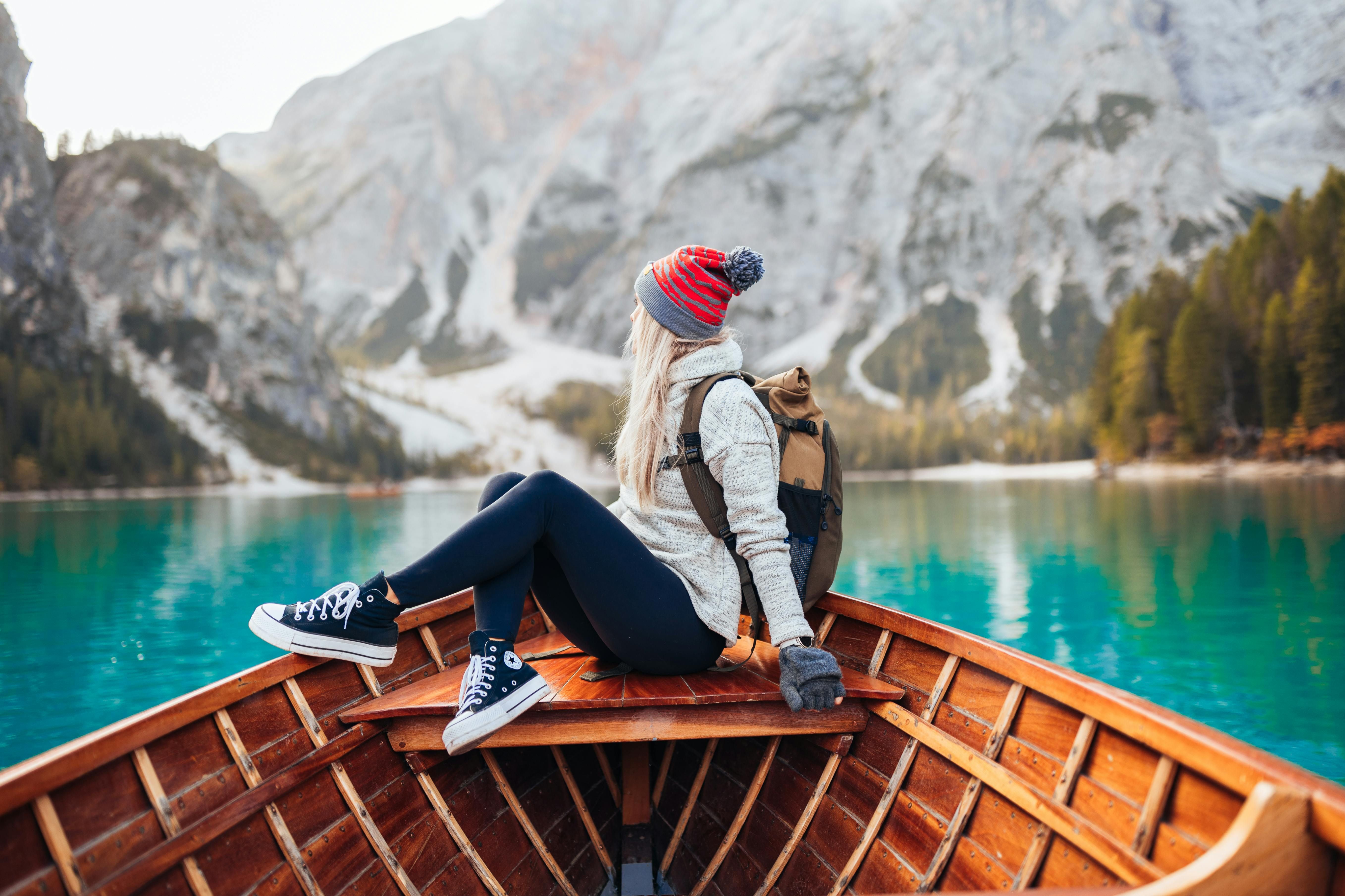 A woman peacefully enjoying the view of the mountains, embracing the mental and emotional benefits of nature therapy.