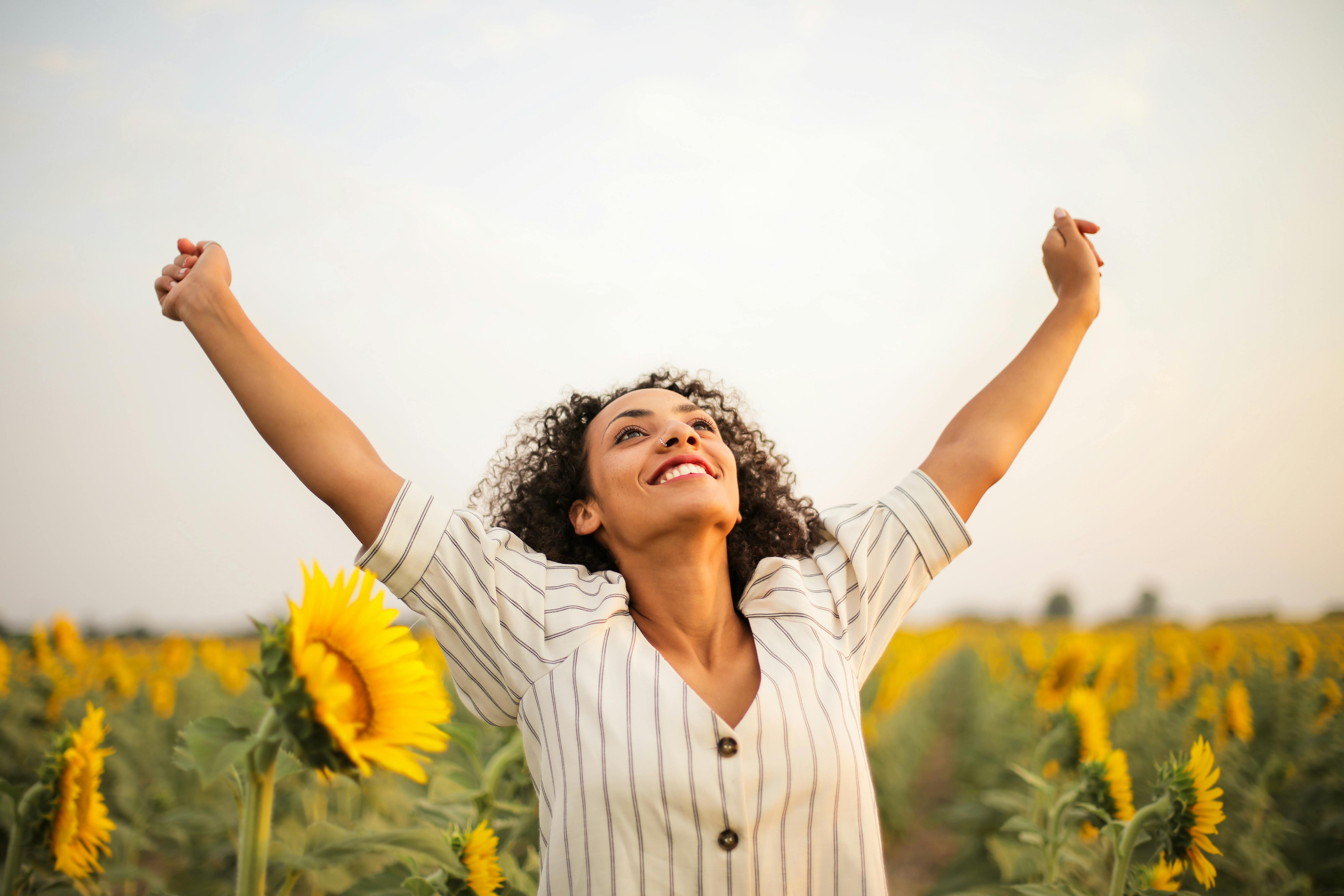 A joyful woman celebrating relief from IBS symptoms, smiling with a sense of freedom and comfort.