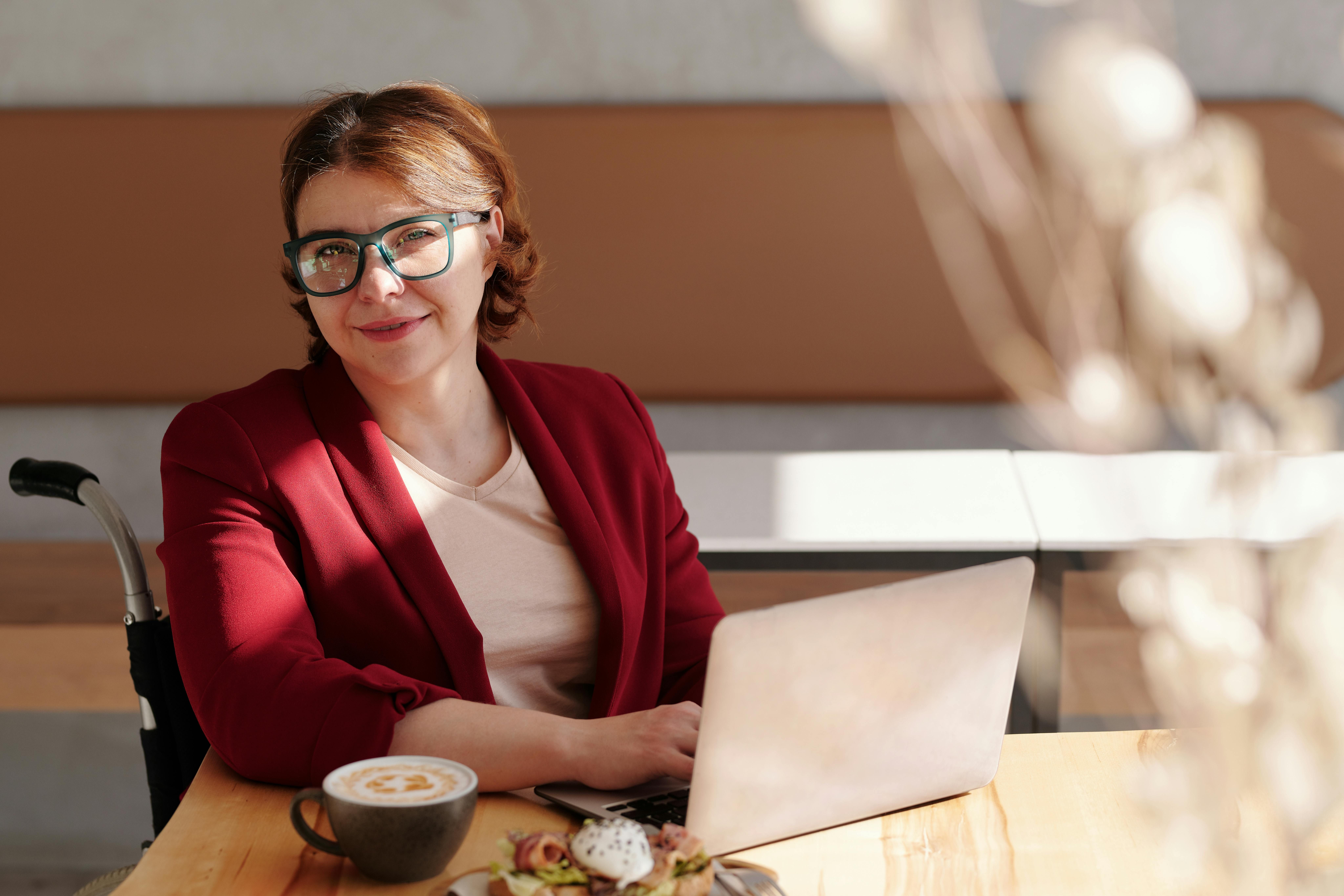 A woman having a business lunch, choosing a healthy meal to maintain her weight loss goals while traveling for work.