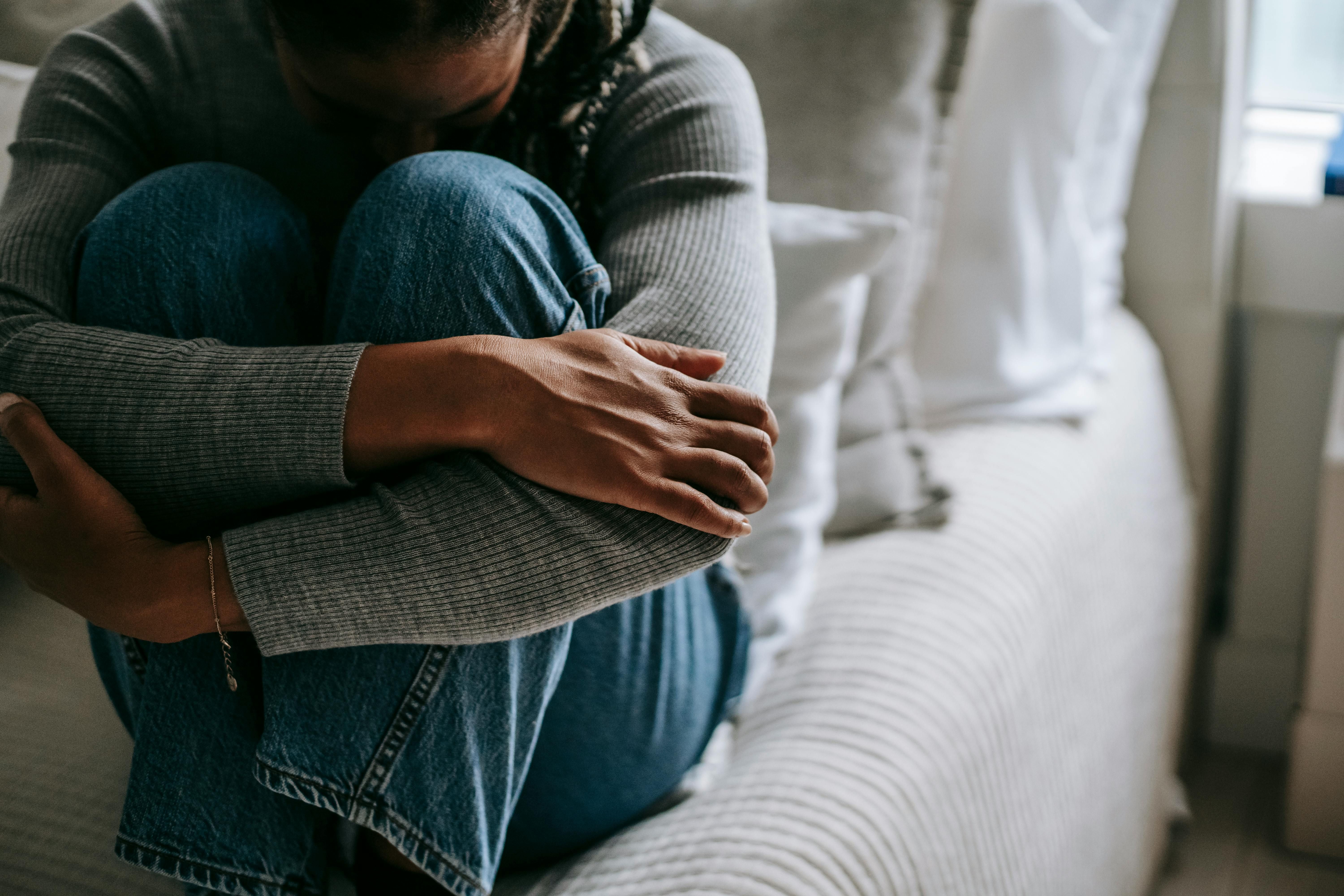 A woman experiencing symptoms of depression, contemplating her weight loss journey.