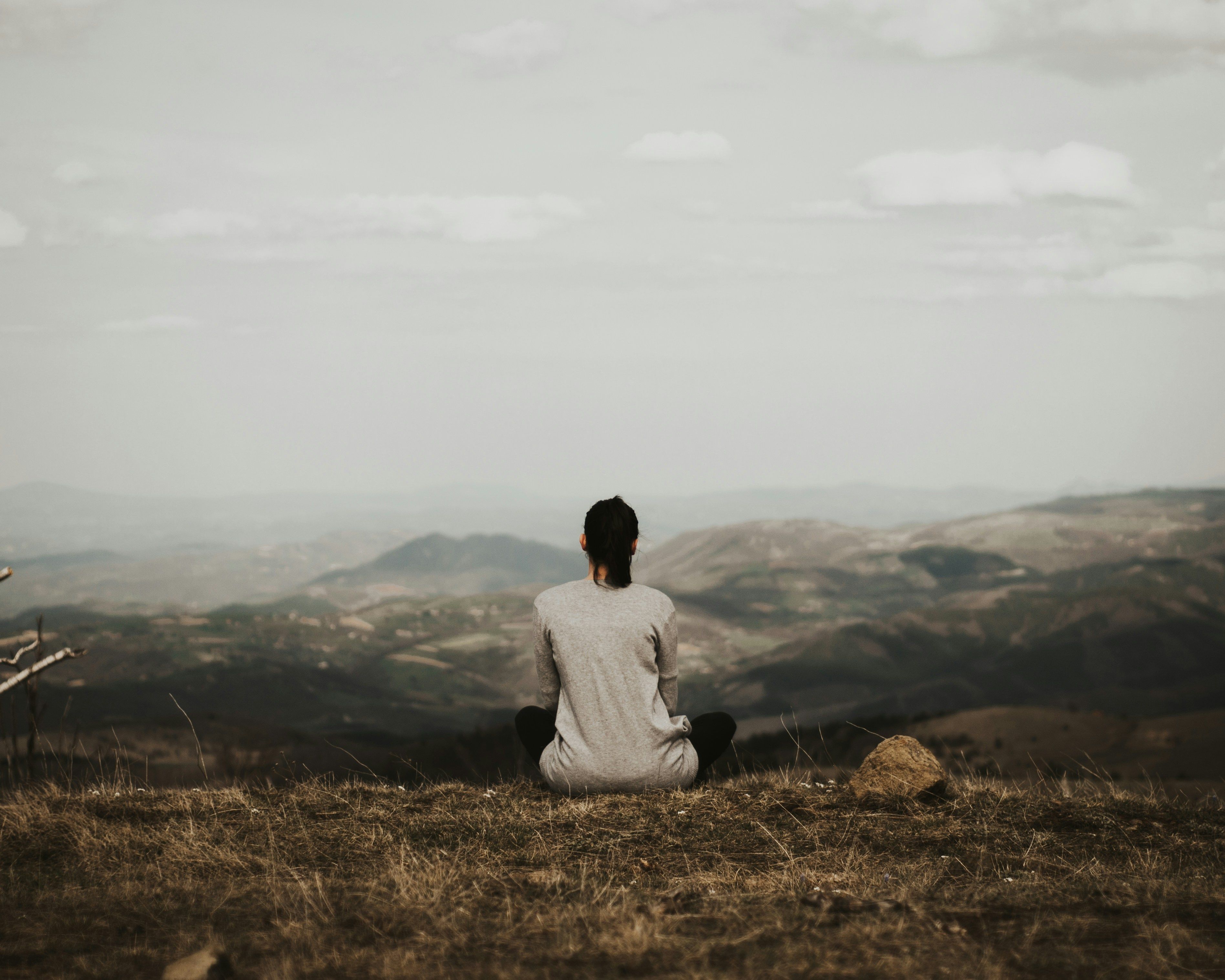 A woman meditating alone, embracing solitude for emotional clarity and personal transformation.