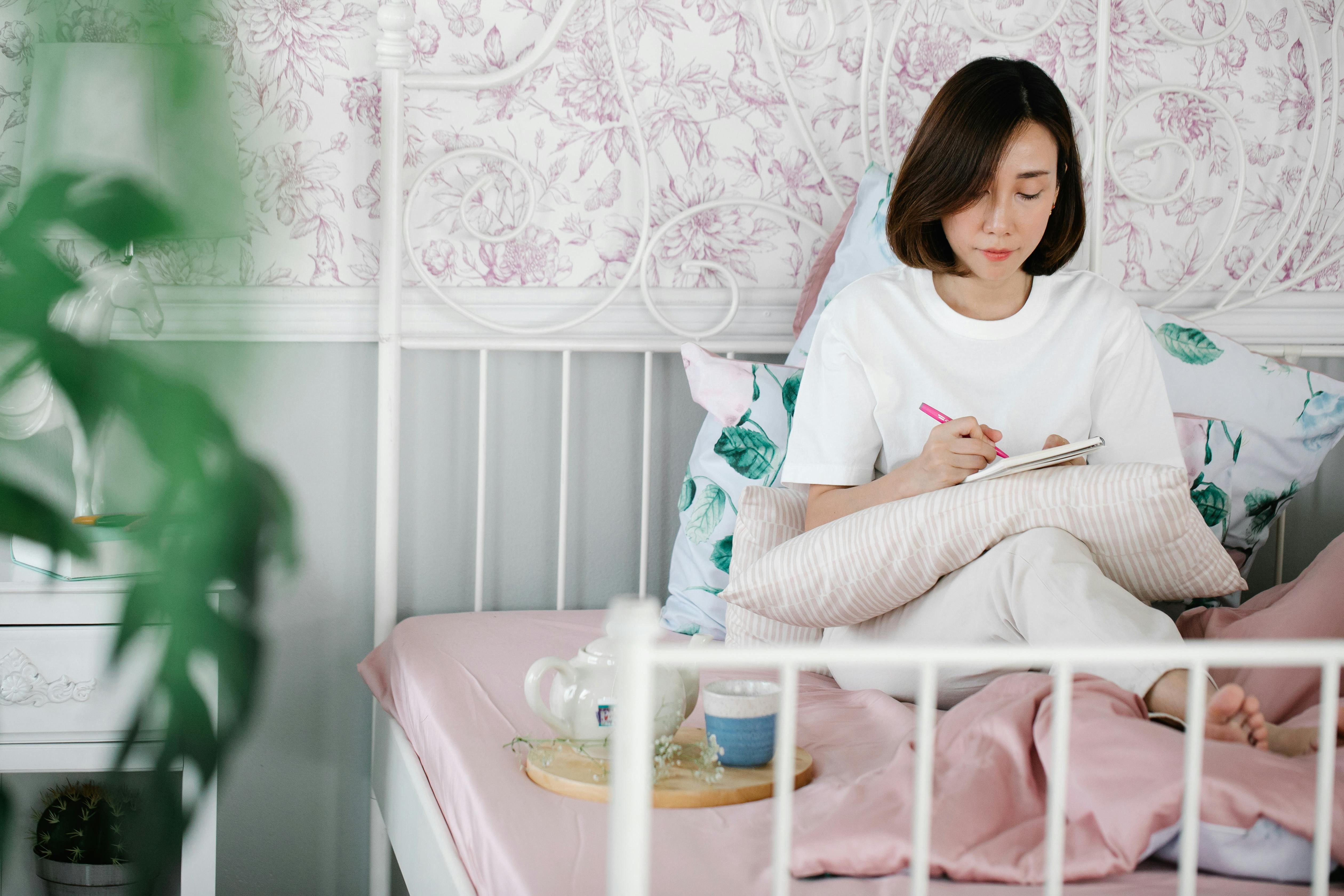 A woman journaling her gratitude, reflecting on the positive aspects of life to boost emotional clarity and mental health.