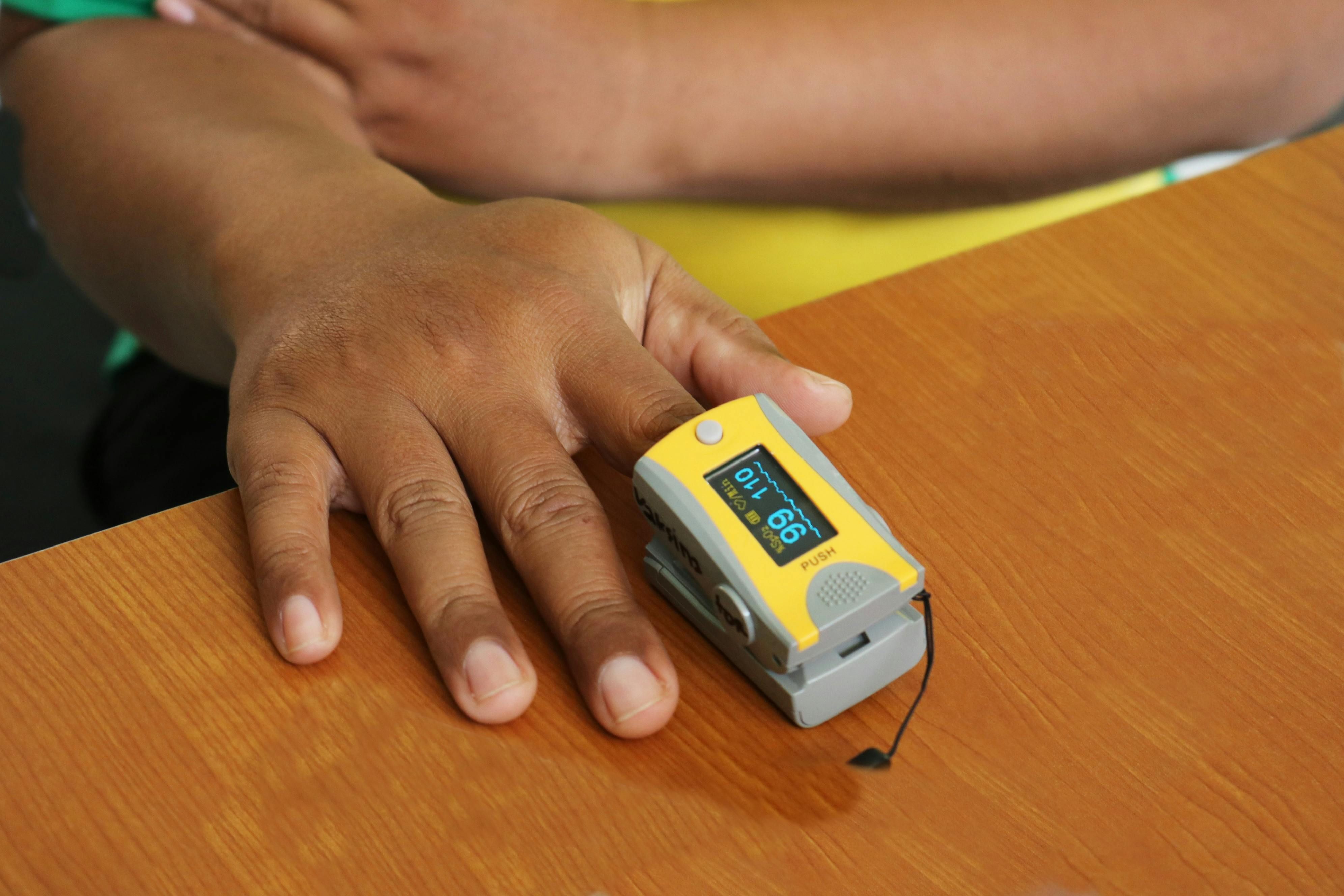 Woman checking her oxygen levels after using CPAP therapy for sleep apnea