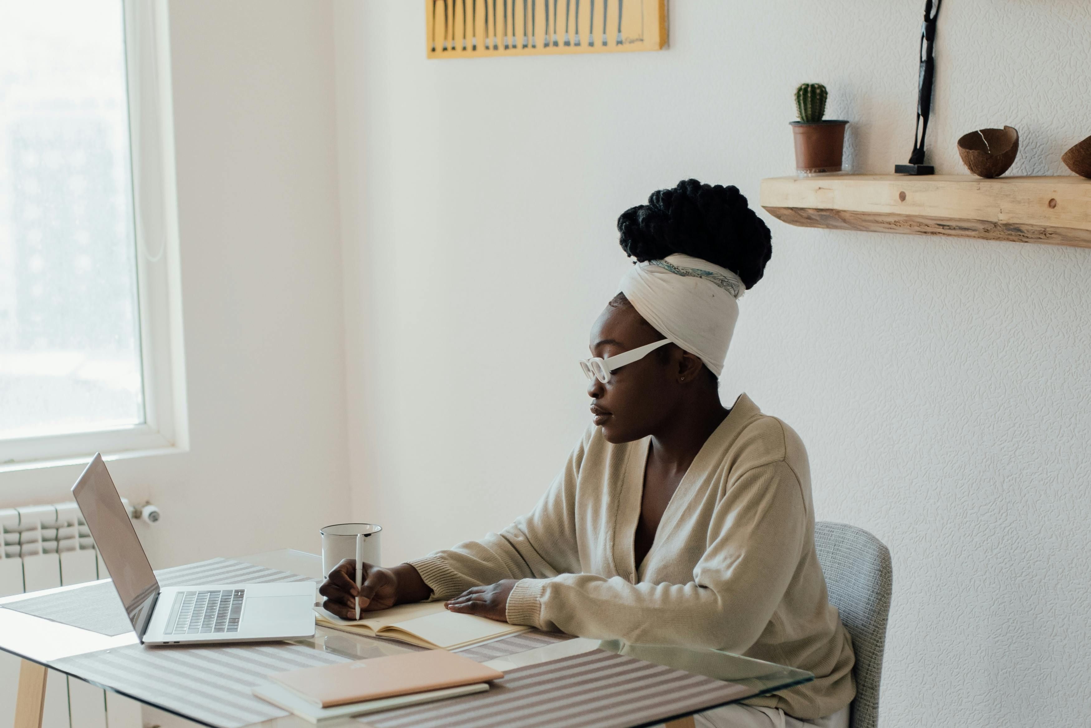 A woman journaling to reflect on and establish personal boundaries for improved emotional health and self-care.