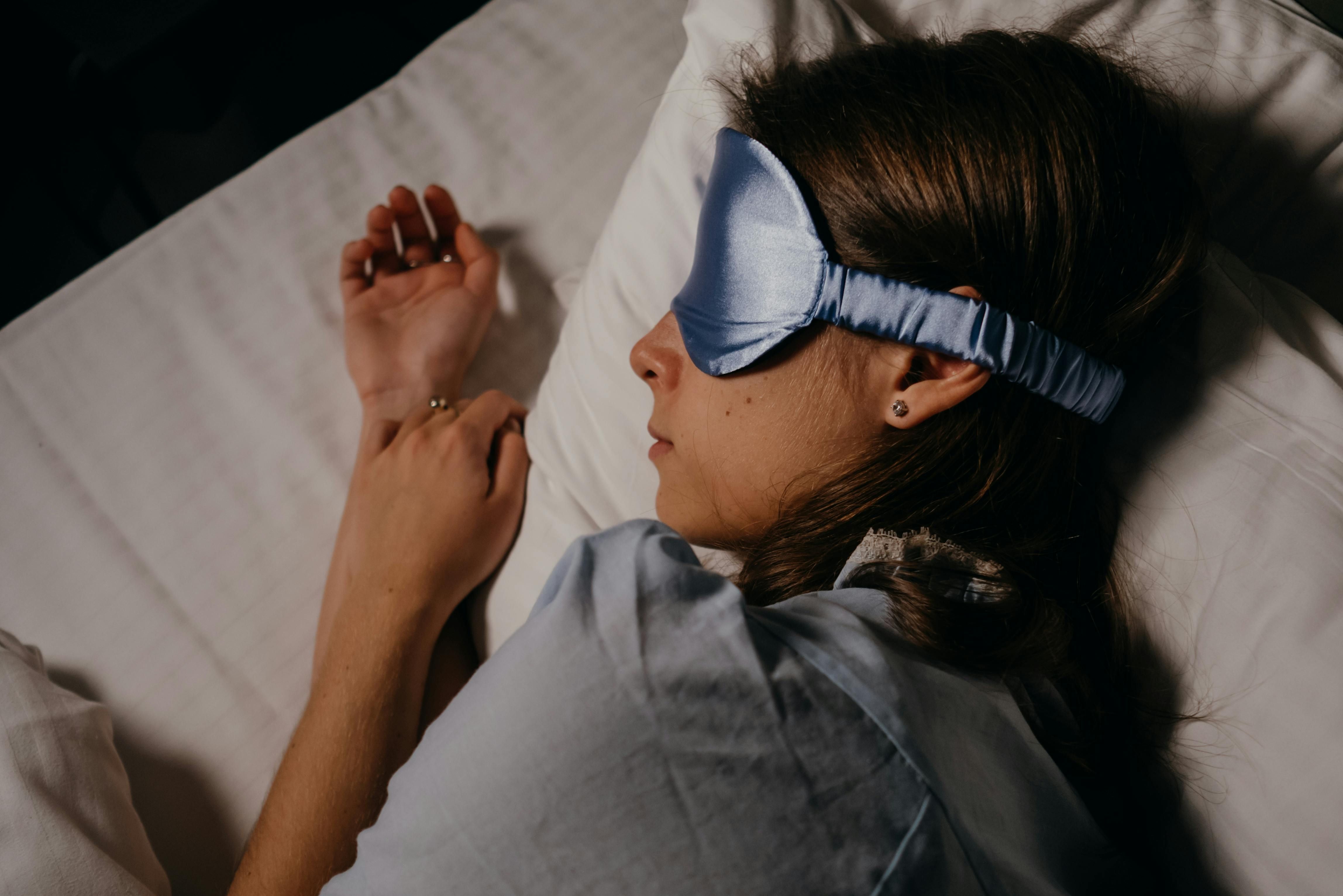 A woman sleeping peacefully after undergoing CBT-I therapy, successfully managing her insomnia and improving sleep quality.