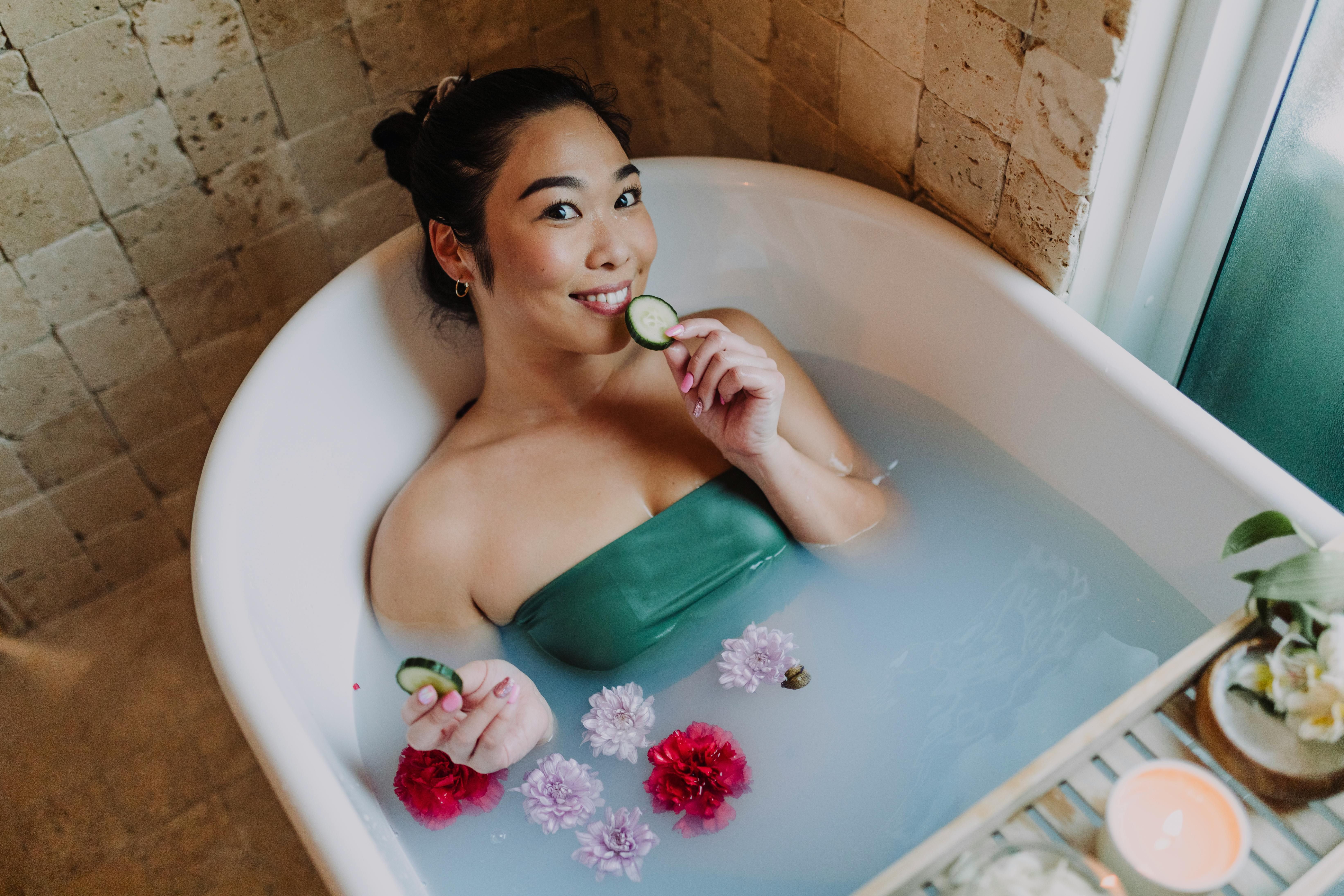 A woman taking a relaxing bath in a hotel, practicing self-care to maintain her weight loss goals during a business trip.