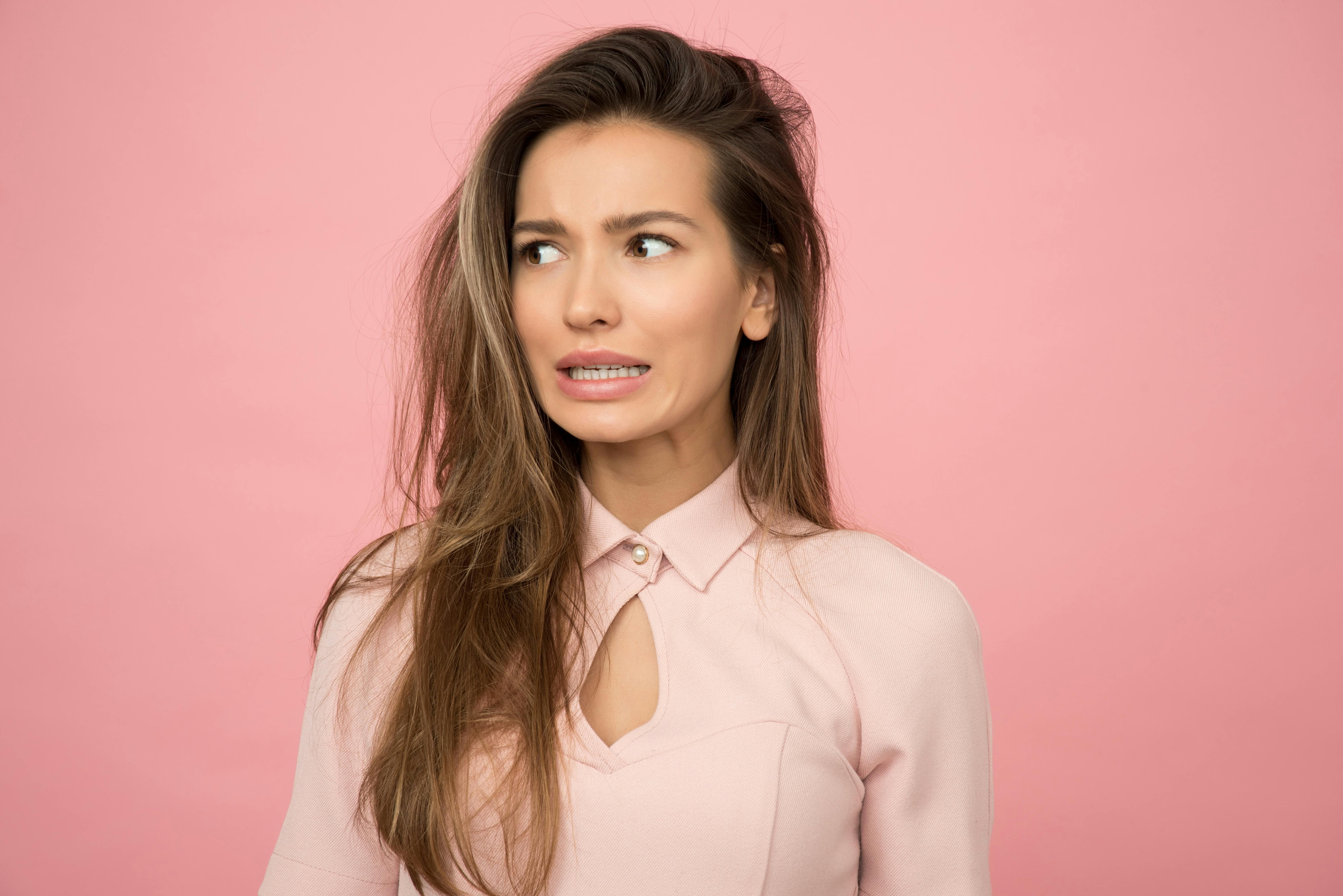 Woman with long, healthy hair showcasing the benefits of hair supplements