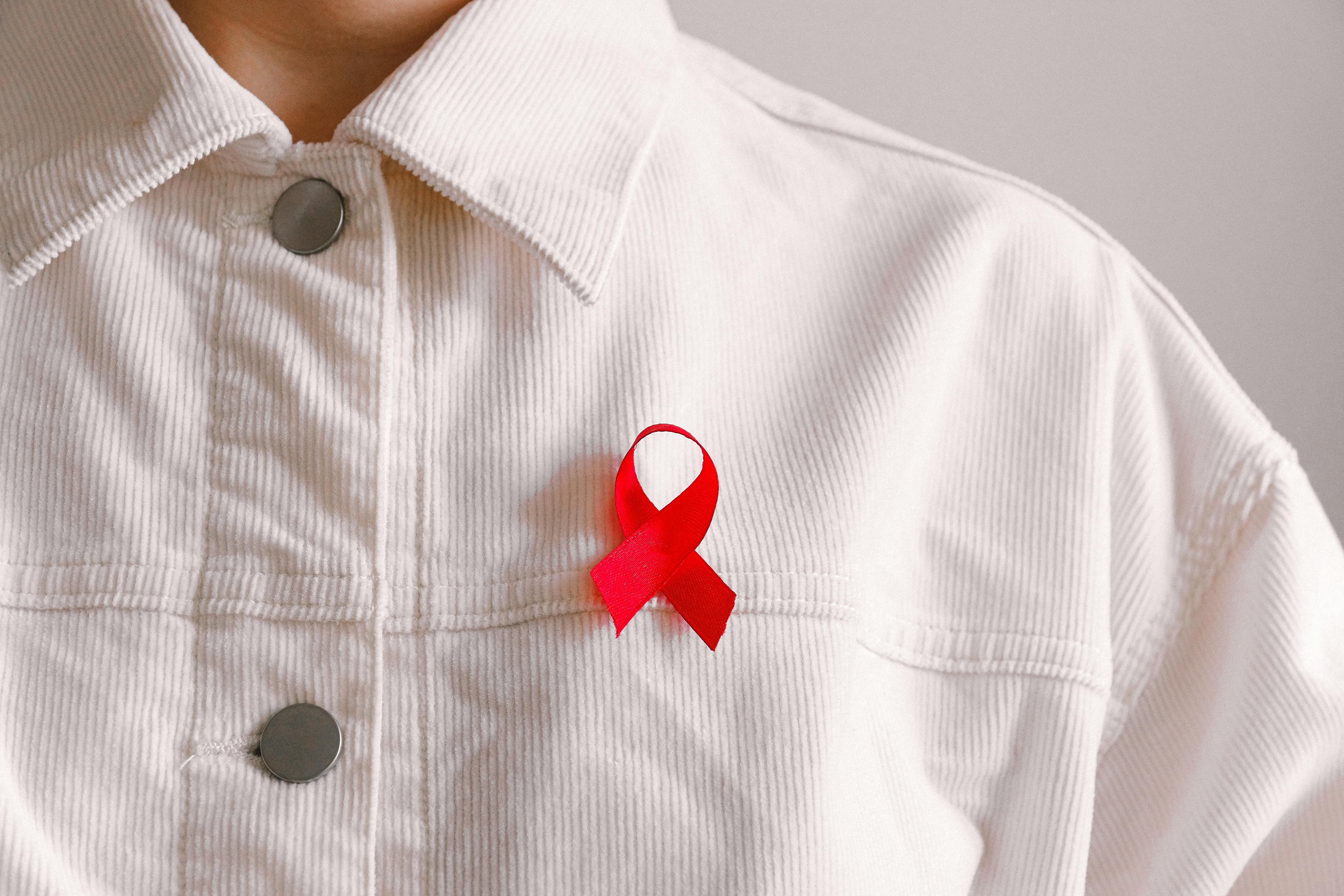 Woman in HIV awareness shirt tracking intermittent fast on phone app